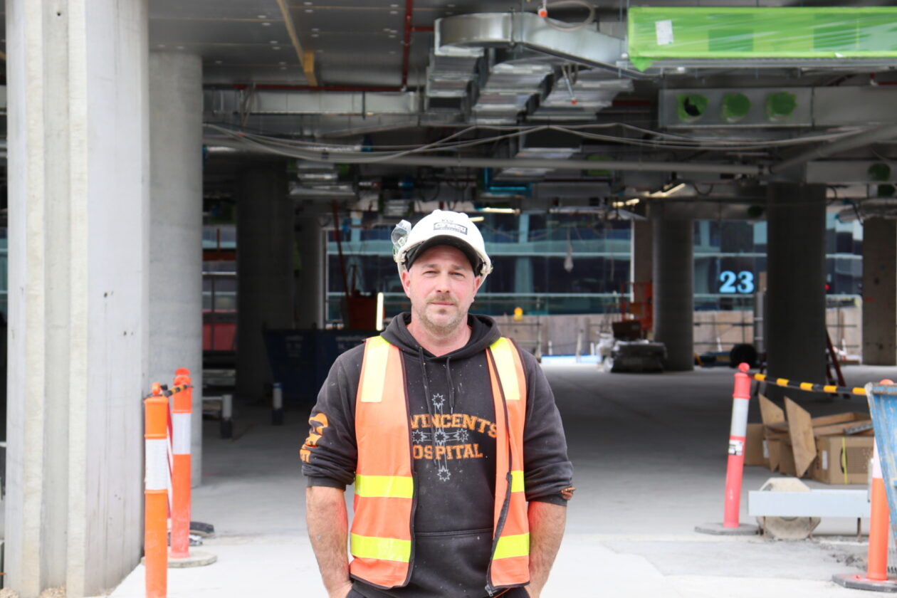 Kevin standing in front of a construction site